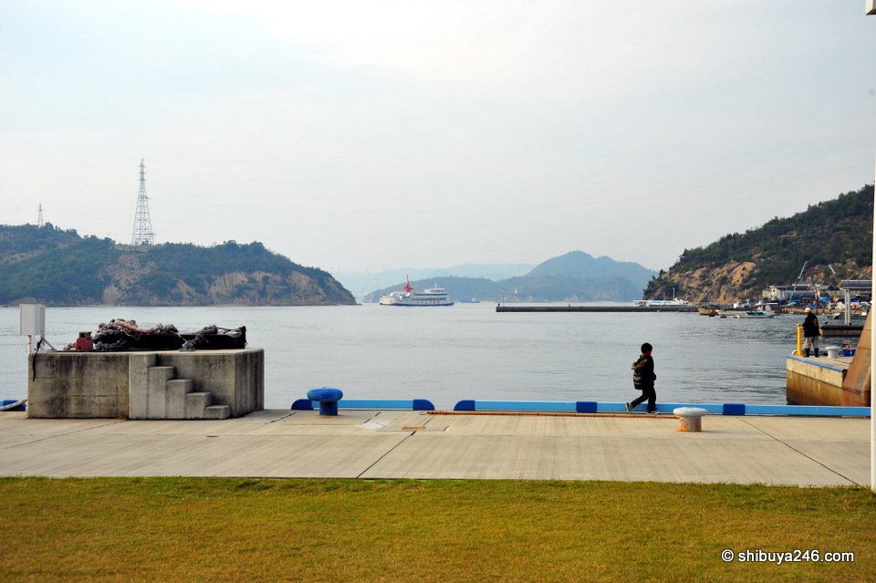 A small pier with a pylon and islands behind