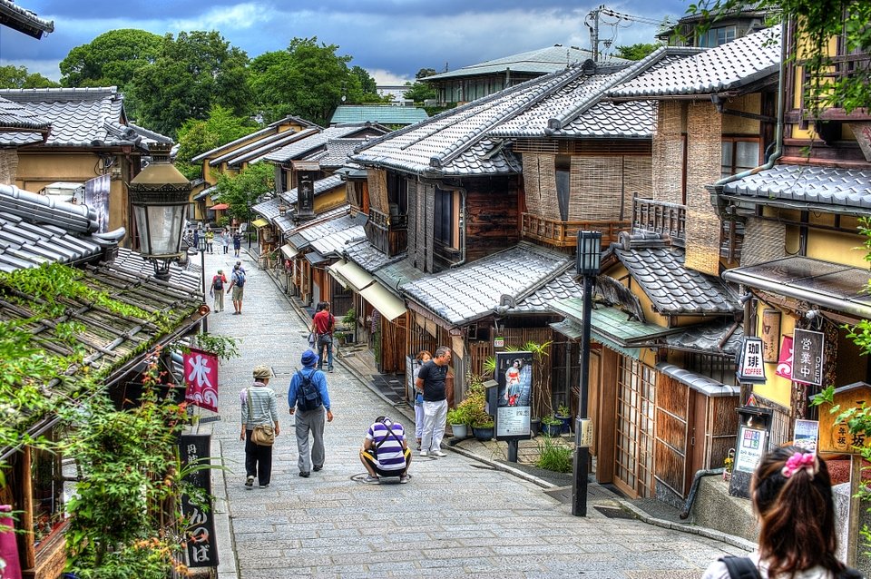 A stone-paved lane lined with old wooden shops