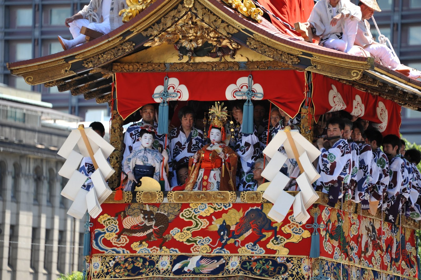 Musicians in blue and white sitting inside a float