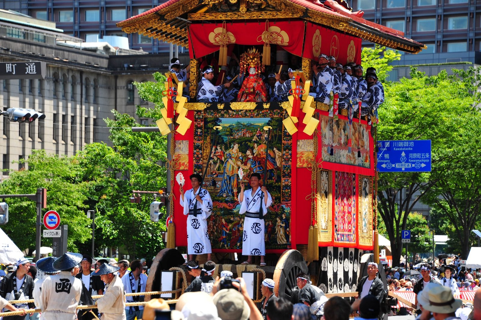 A tall red float with people inside