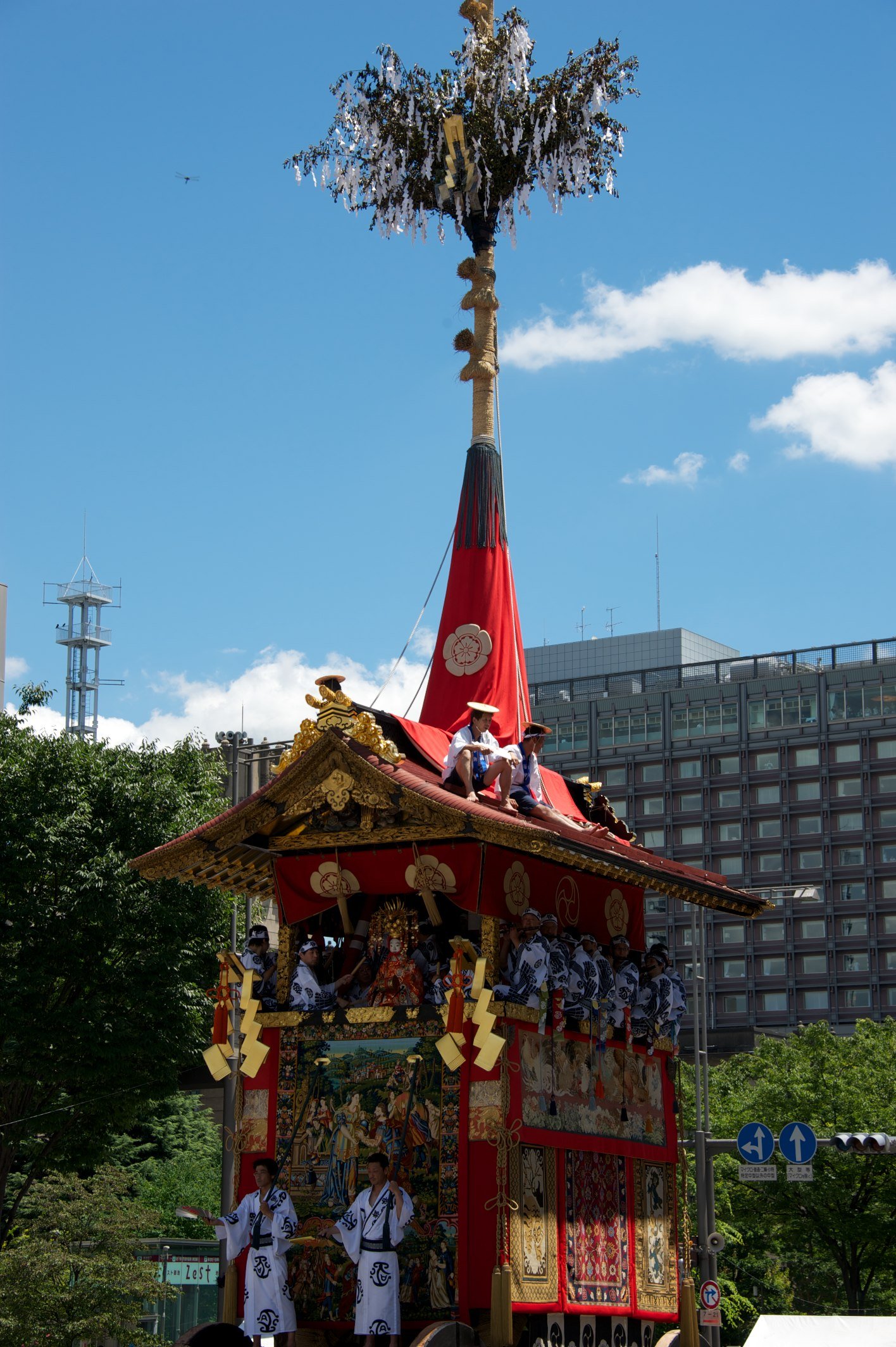 A tall pole rising from the top of a float