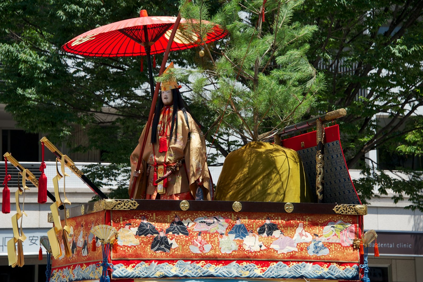 Close up of the figure and umbrella on a float