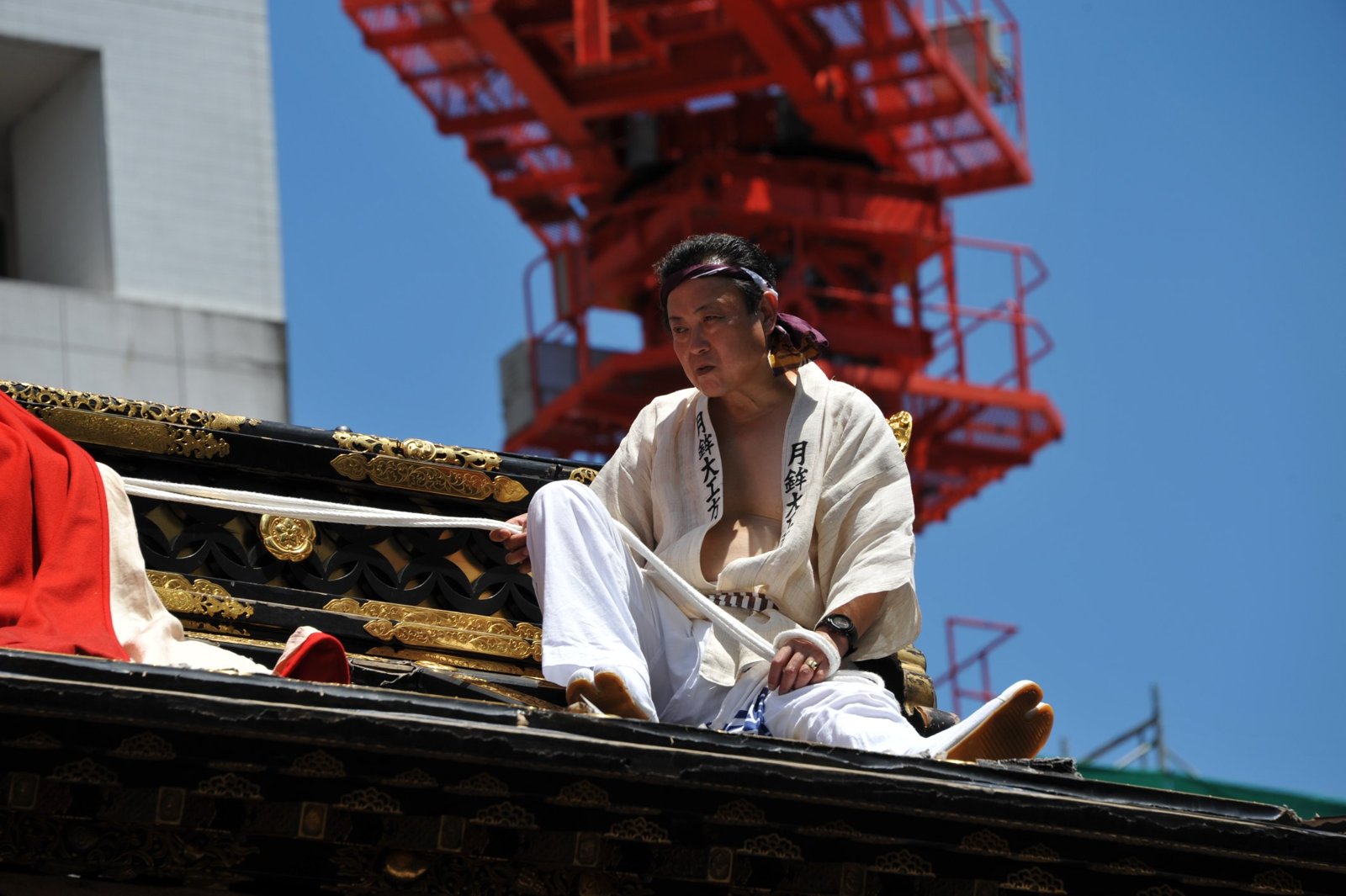 A man sitting on the roof of a float