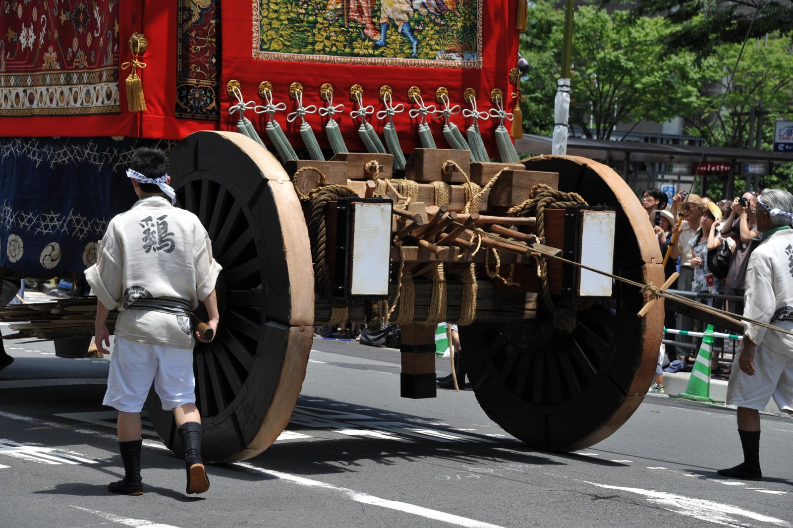 The wheels of a float from behind