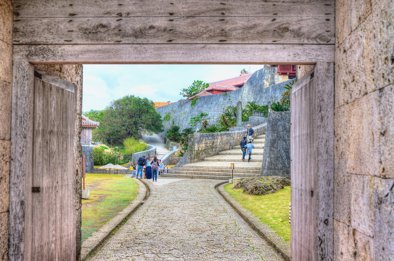 A view through an old wooden gate to stone steps