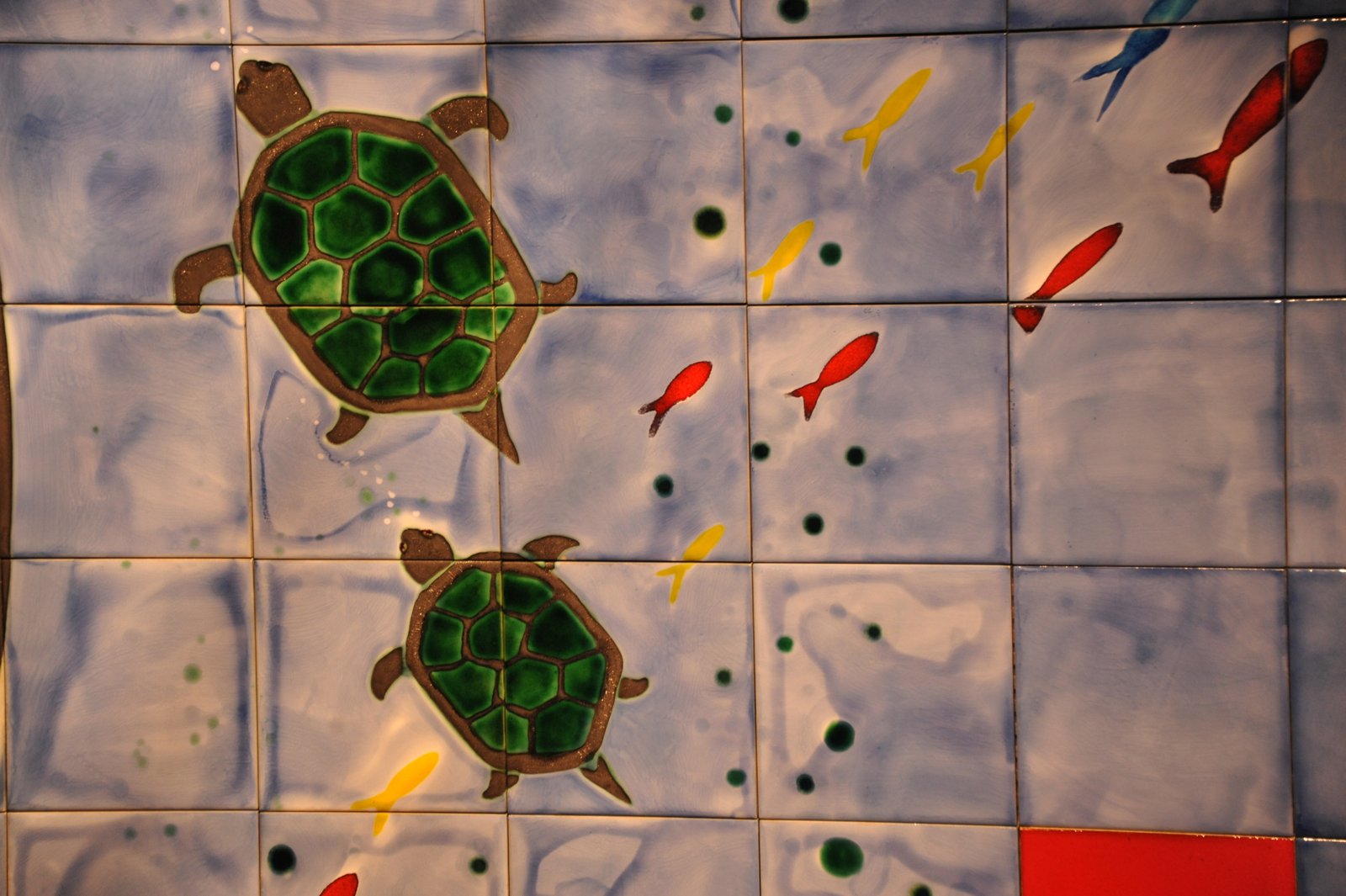 Tile mosaic of turtles and small red fish