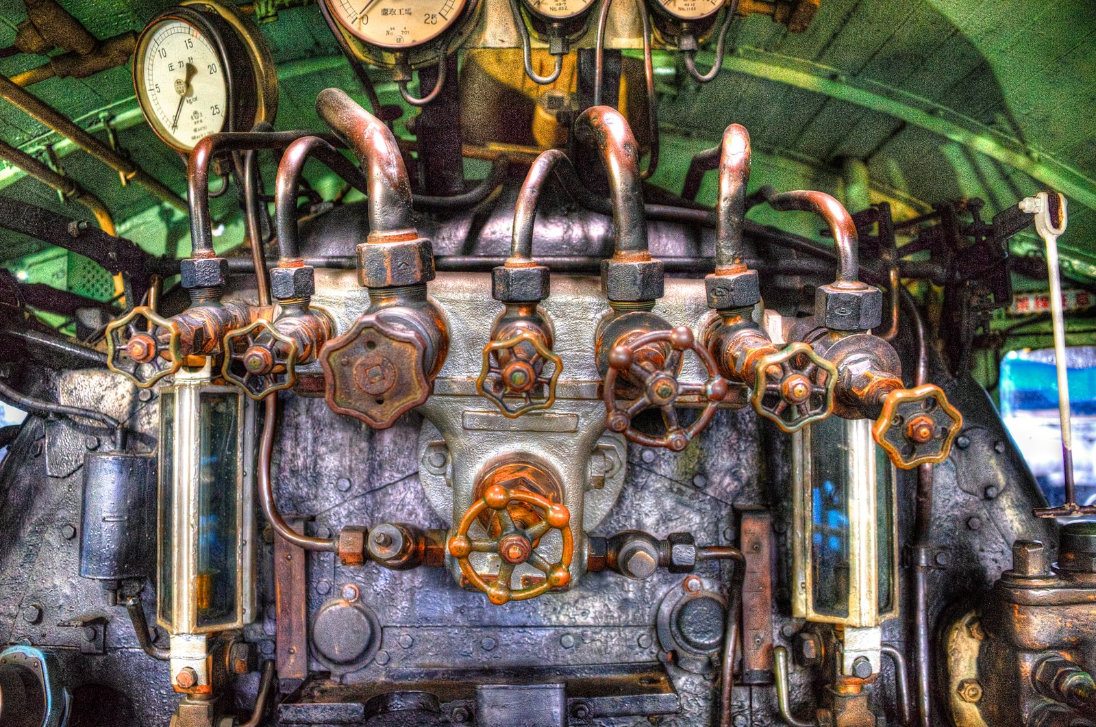 Valves, pipes and pressure gauges inside the cab of a steam locomotive