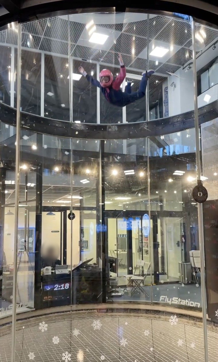 A flyer in a pink helmet high up in the FlyStation tunnel.
