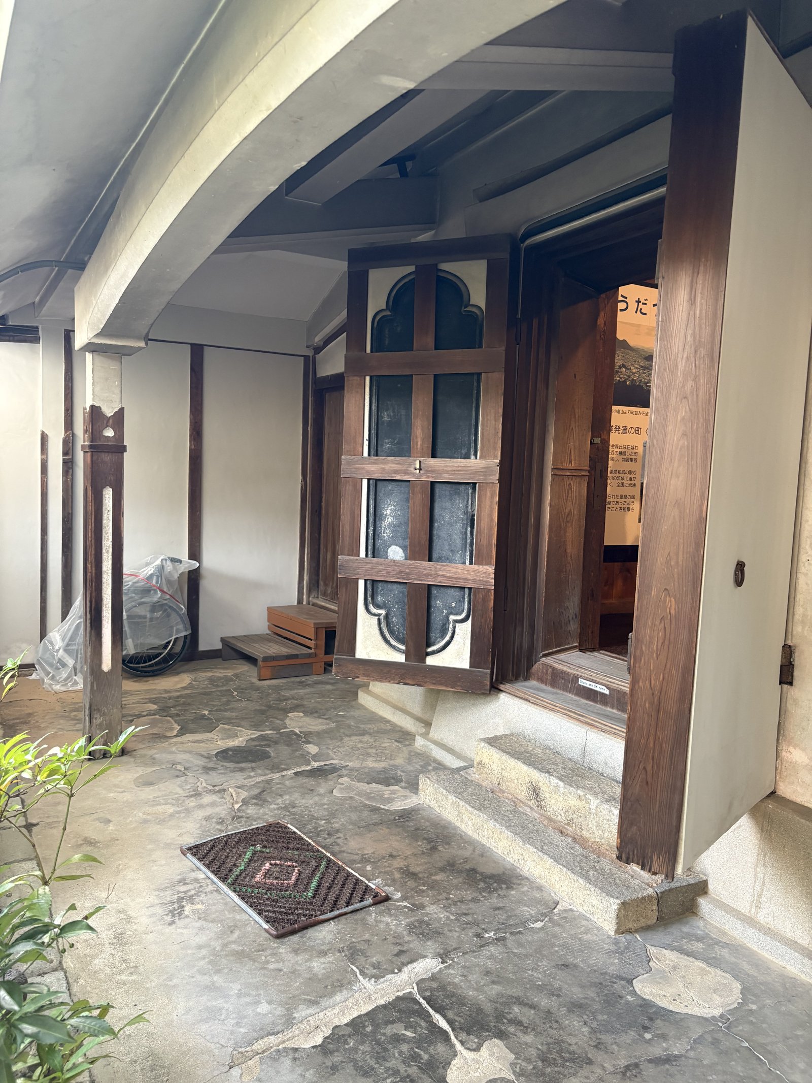 An entrance with a wooden door and a glass window